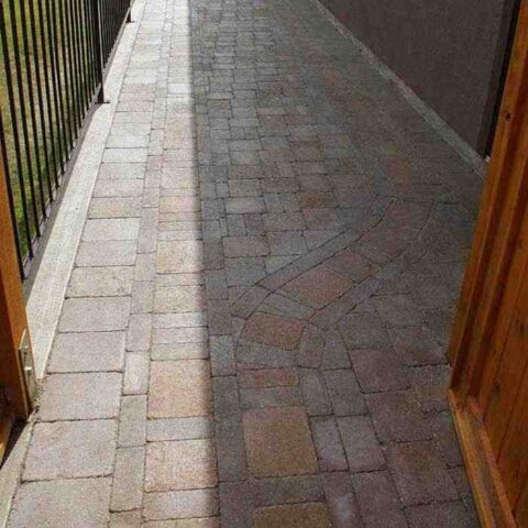paving stone walkway on the side of the house