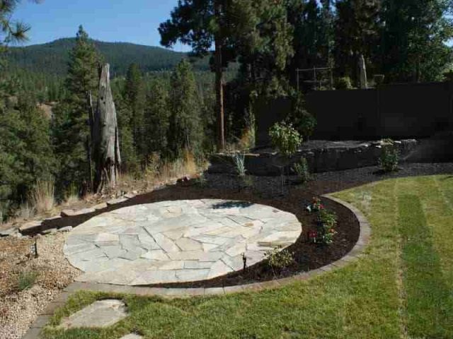 circular flagstone patio and mulch garden beds - Nanaimo landscaping